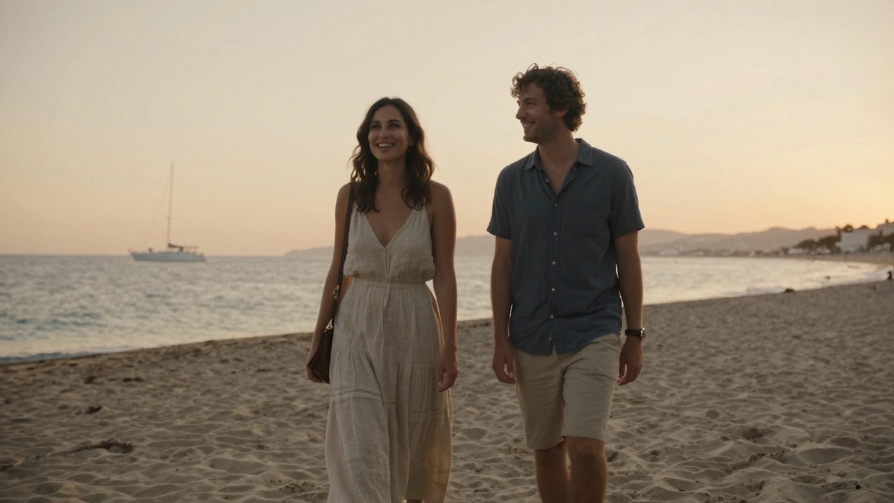 A couple walking peacefully along a Cannes beach at sunset, blending into the serene coastal atmosphere.
